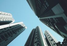 주택 공급 늘리고 세 부담 낮추고 주거 복지는 든든하게 looking up at tall buildings in a city