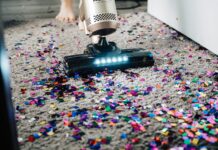 장마철 알레르기 대처법 a person using a vacuum to clean a carpet