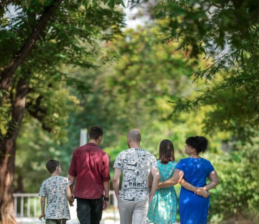 부모와 자녀의 건강한 관계 만들기 man in red t-shirt and gray pants holding hands with boy in blue t-shirt
