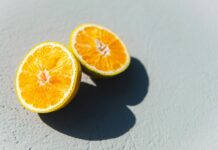 비타민과 미네랄이 풍부한 식단으로 면역력 강화하기 two oranges cut in half sitting on a table
