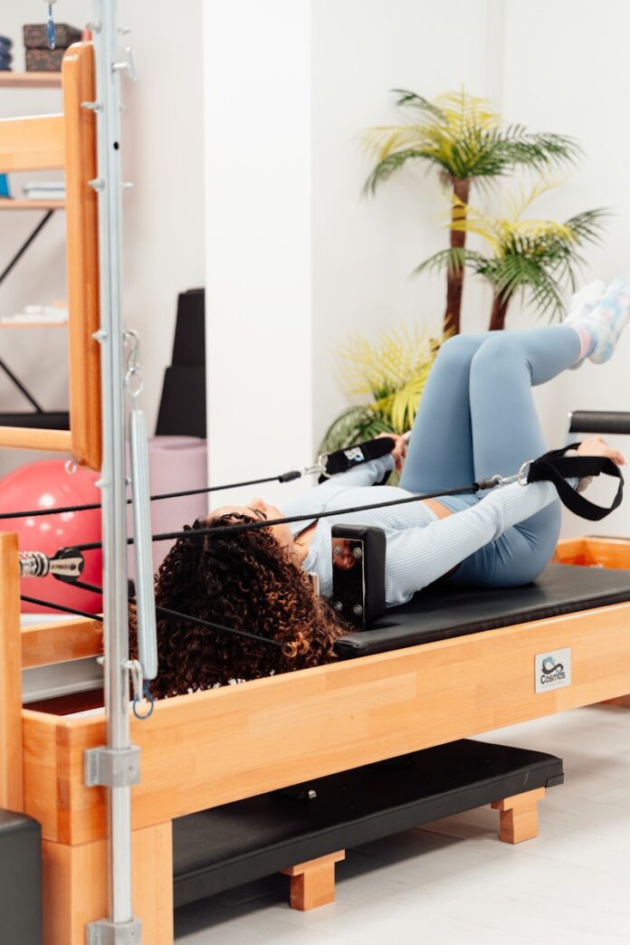 a woman laying on a bench in a gym