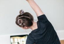 집에서 쉽게 할 수 있는 홈트레이닝 프로그램 woman in black t-shirt and black pants lying on black yoga mat