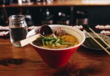 일상에서 면역력을 높이는 간단한 식단 팁 soup with vegetable beside chopsticks and glass of water