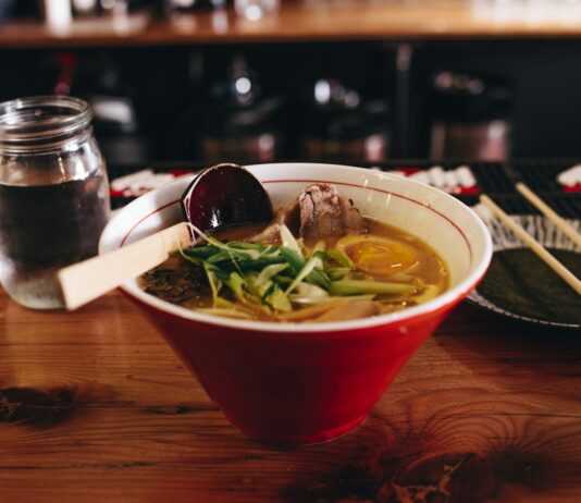 일상에서 면역력을 높이는 간단한 식단 팁 soup with vegetable beside chopsticks and glass of water