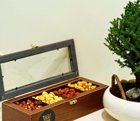심장 건강을 지키는 식습관: 심혈관 질환 예방을 위한 가이드 a wooden box filled with nuts next to a potted tree