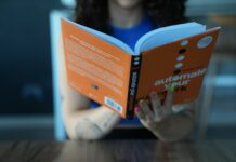 2025년, 새로운 경력 개발의 기회 a woman sitting at a table reading a book