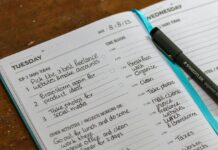 새해, 스트레스 관리를 위한 실천 전략 a notebook with a pen on top of it