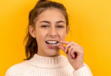 치아교정을 할 가장 좋은 시기? smiling woman in white knit sweater