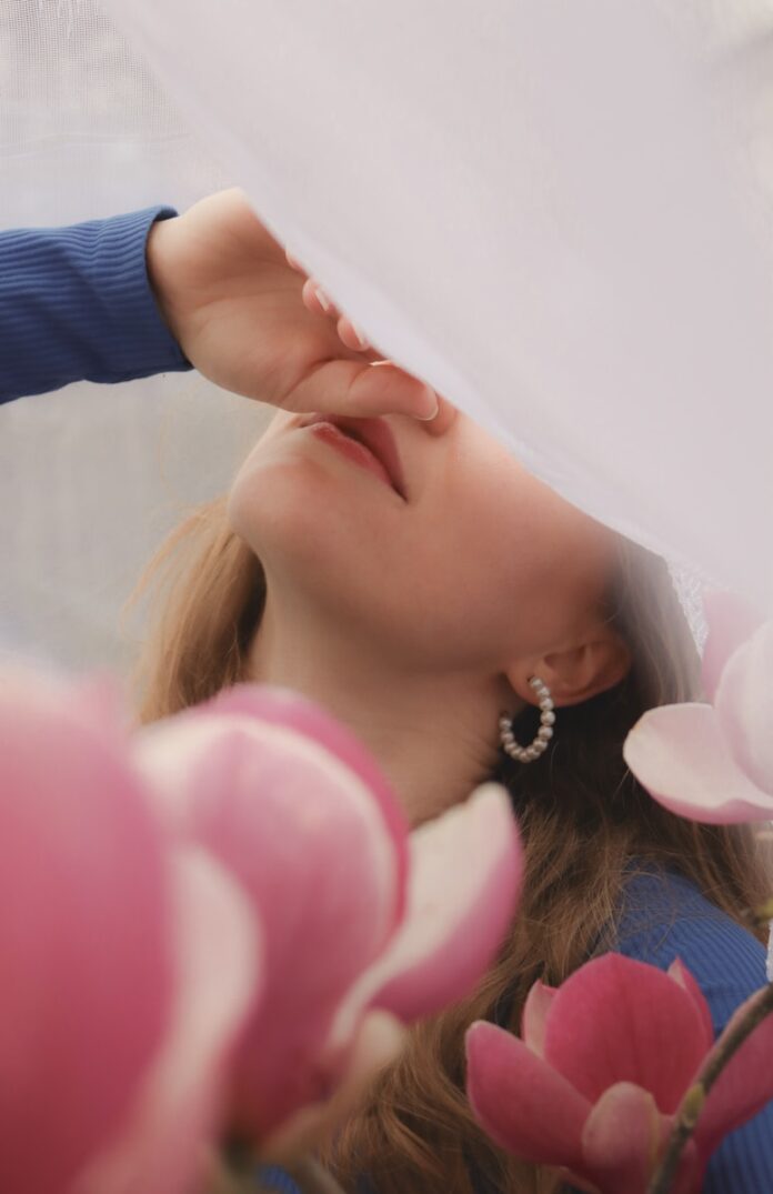 a woman with her eyes closed and her hand on her head