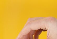 뼈 건강을 지키는 첫걸음, 골다공증 예방의 중요성과 실천법 person holding white cigarette stick