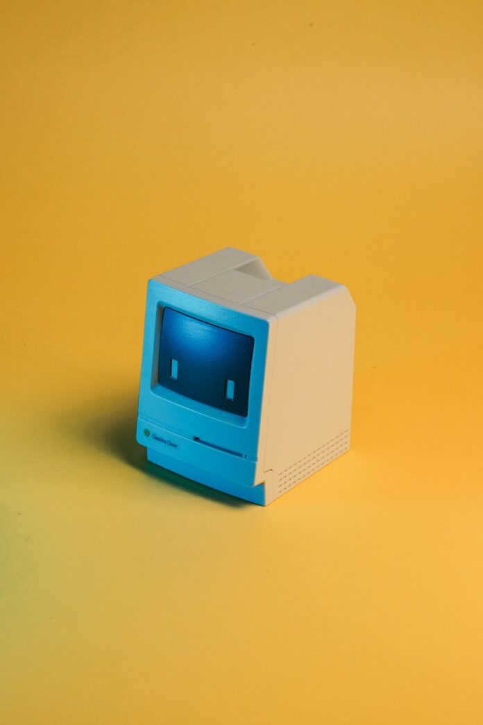 A miniature, vintage macintosh computer toy.