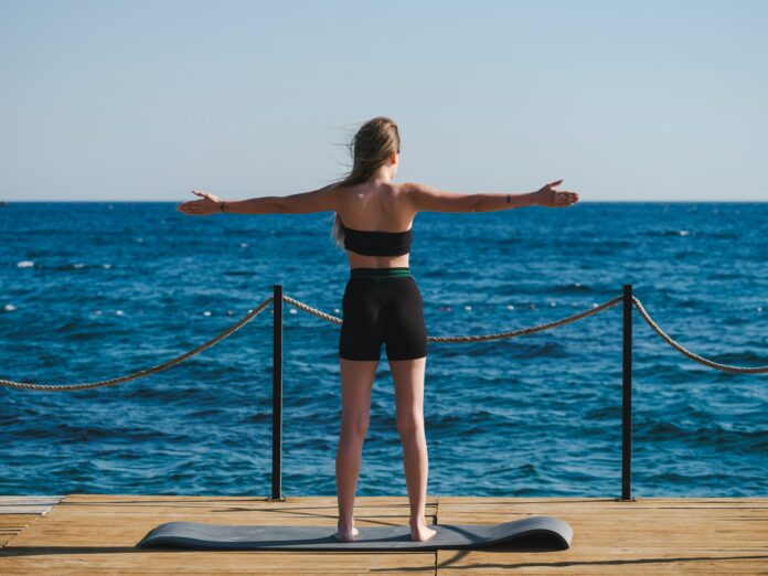 a person doing yoga on a dock