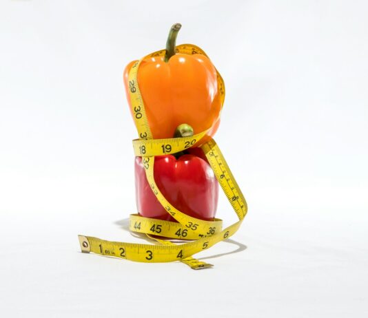 “운동은 하는데 살이 빠지지 않아요”… 혹시 ‘근감소형 비만’일 수 있습니다 a measuring tape wrapped around a bell pepper