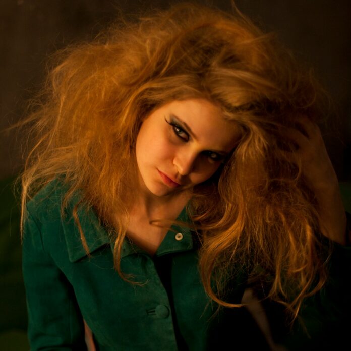 woman in green button up shirt wearing black framed eyeglasses