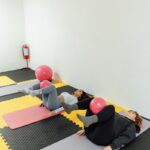 필라테스, 몸과 마음을 건강하게 다지는 현대인의 운동법 a group of people doing yoga in a room