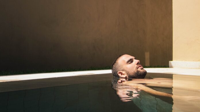 Photo by Logan Stone man floating on water