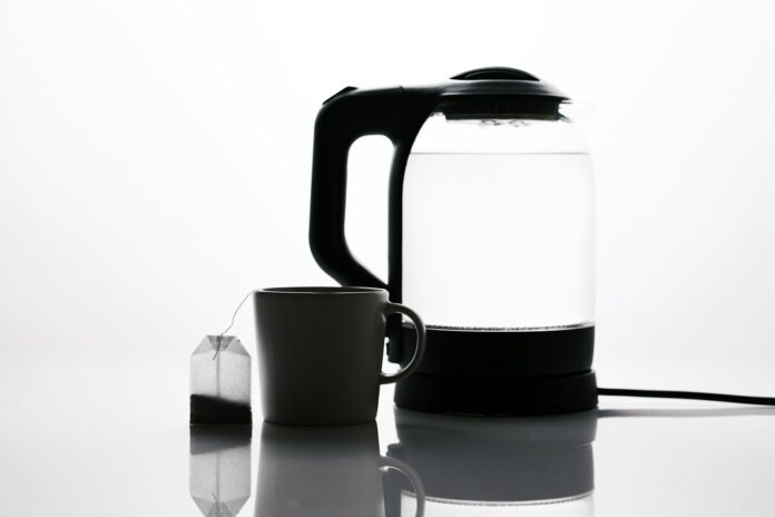 Photo by engin akyurt a black and white photo of a kettle and a cup