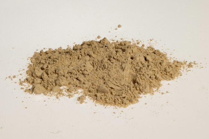 Photo by Aleksander Saks a pile of dirt sitting on top of a white table