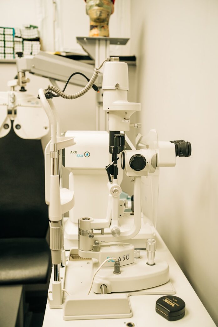 a microscope sitting on top of a table next to a black chair