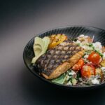 “지속가능한 식단, 일상 속 작은 변화로 만들기” grilled meat with green vegetable on black ceramic plate