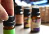 일상 속에 스며드는 대체요법, 간편하게 즐기는 건강 습관 a hand touching a bottle of essential oils