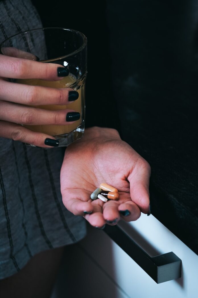 Photo by Yves Cedric Schulze a person holding a glass of beer