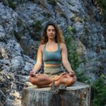 “마음 챙김의 시대, 일상 속 실천으로 정신건강 지키기” woman in blue spaghetti strap top sitting on brown wooden log