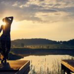 집에서 쉽게 시작하는 ‘마음 챙김’ 루틴…바쁜 일상 속 마음 건강 지키기 silhouette of woman standing on brown wooden dock during golden hour
