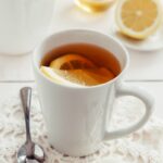 일상 속 대체요법, 건강을 더하는 새로운 습관으로 자리 잡다 a cup of tea with a slice of lemon on a doily