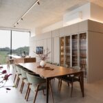만성피로, 생활 속 루틴이 해법… ‘슬로우 라이프’로 활력 더하기 Modern dining room with large table and wine cabinet.