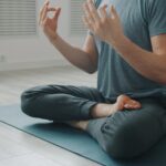 과도한 자기관리의 역설: 건강을 쫓을수록 멀어지는 이유 Man meditating in lotus pose on yoga mat.