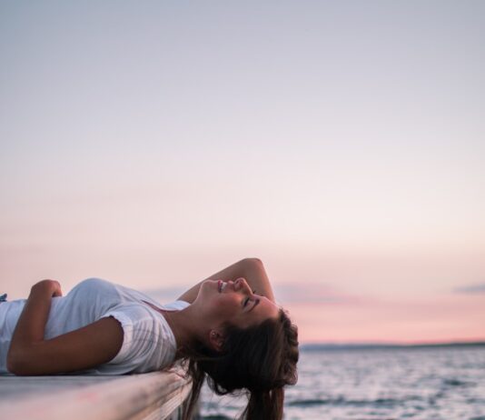 호흡·자세·미세 움직임이 몸과 마음을 연결하는 섬세한 통로 woman lying on white dock
