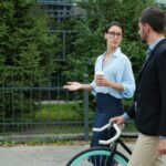 일상 속 만성피로, 휴식과 소소한 변화로 극복하기 Two colleagues walking with a bicycle outdoors