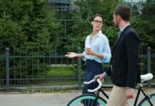 일상 속 만성피로, 휴식과 소소한 변화로 극복하기 Two colleagues walking with a bicycle outdoors