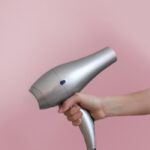 건강한 모발, 생활 속 실천으로 관리하세요 person holding gray corded hair dryer