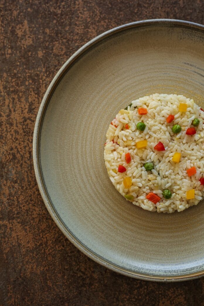 Photo by Valentin Balan a plate of rice with vegetables