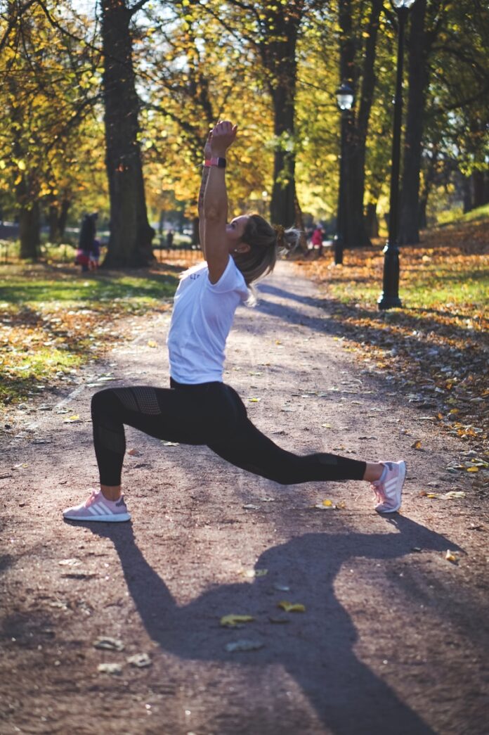 Photo by Charlotte Karlsen woman stretching on pathway