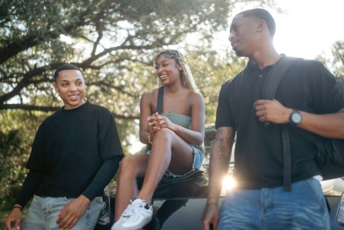 Photo by Land O'Lakes, Inc. Three friends talking outdoors on a sunny day.