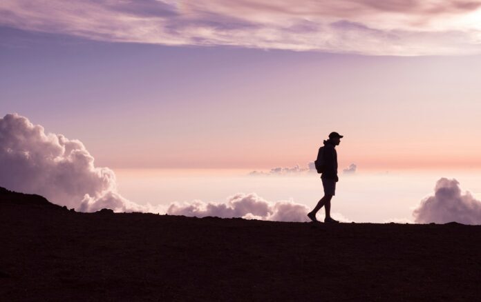 Photo by Jad Limcaco silhouette of person walking under white clouds