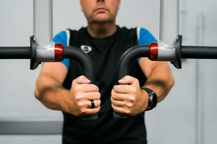 A man holding a pair of handles in his hands