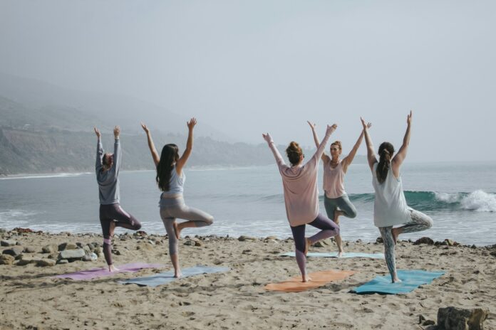 Photo by Kaylee Garrett five woman standing on seashore