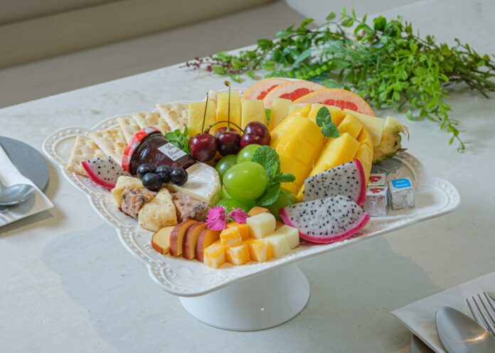 Photo by sehoon ye a platter of fruit and cheese on a table