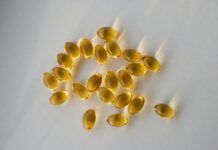 “내 몸을 위한 영양 관리, 보충제 올바르게 활용하는 법” a pile of fish oil capsules sitting on top of a table