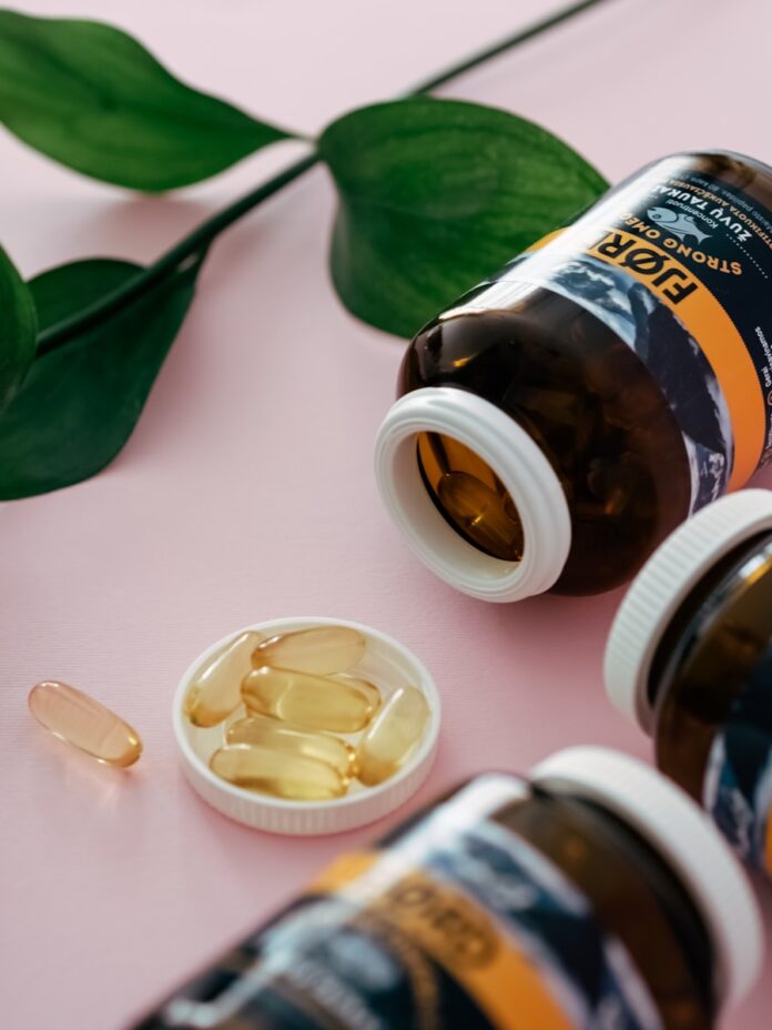 Photo by Natallia Photo a bottle of fish oil next to two bottles of fish oil