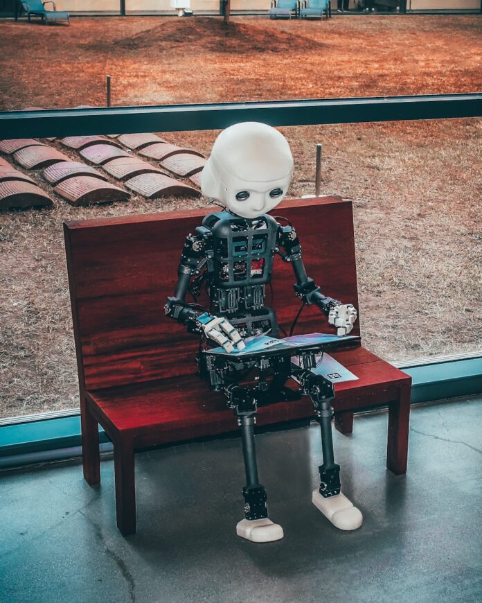 Photo by Andrea De Santis black and white robot toy on red wooden table