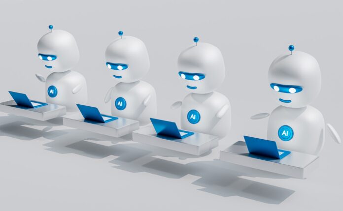 Photo by Mohamed Nohassi a group of white robots sitting on top of laptops