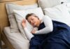 ‘꿀잠’ 위한 새로운 루틴… 수면 트렌드와 실천법 둘러보기 a woman sleeping on a bed with a blue blanket