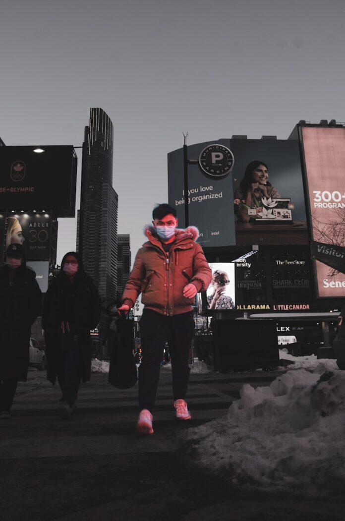 a woman wearing a face mask walking down a street