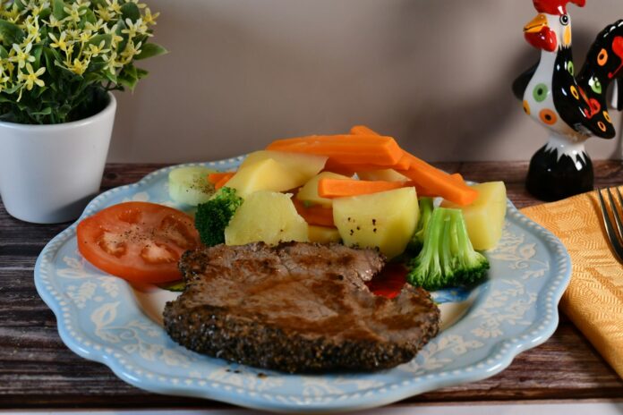 Photo by Sarto Lepage Steak with boiled potatoes, carrots, broccoli, and tomato
