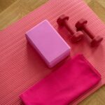 필라테스, 일상 속 건강한 움직임으로 인기…집에서도 쉽게 실천하는 비법은? pink dumbbell on pink textile